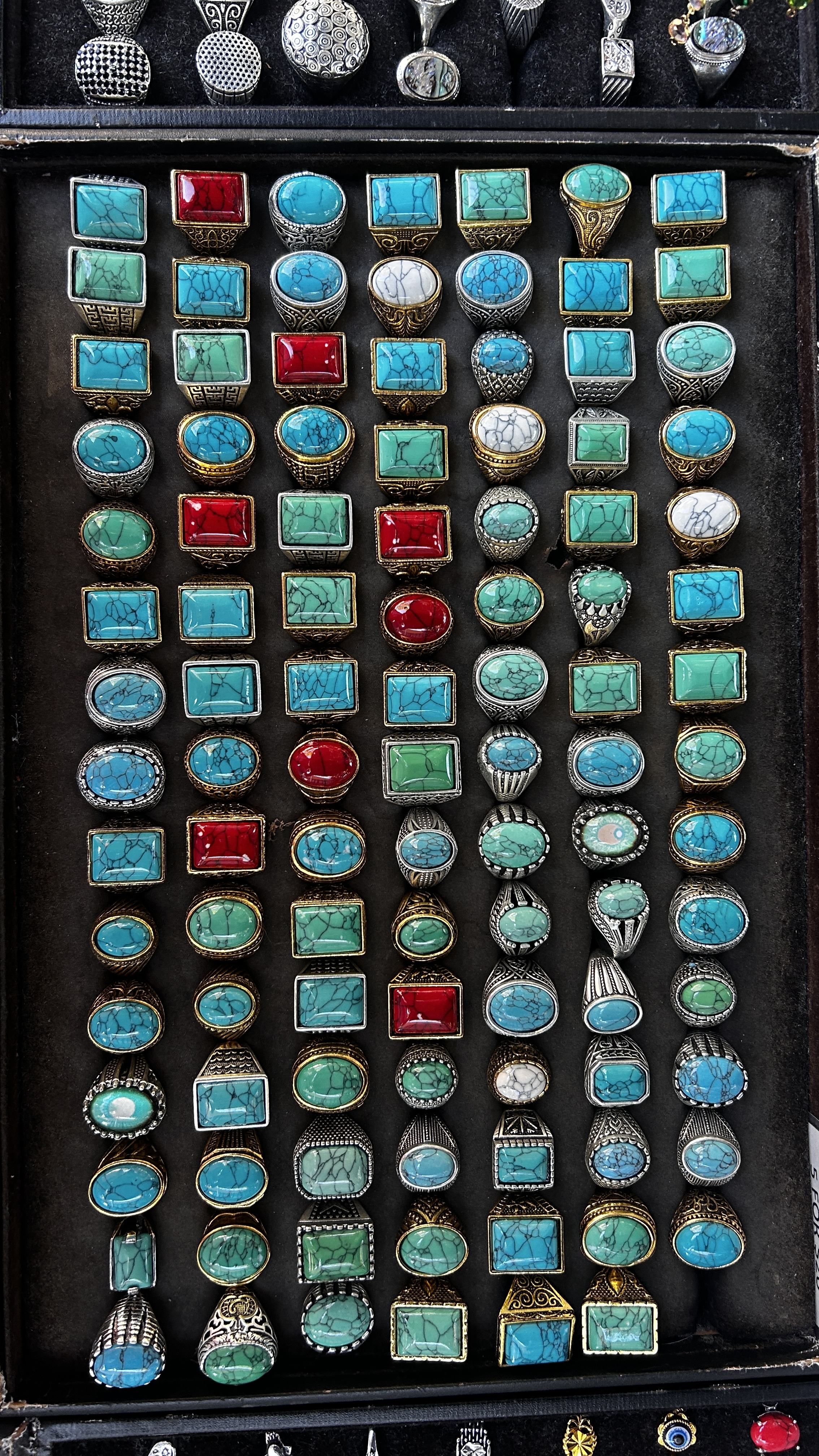 Turquoise statement rings in silver and gold-tone settings.