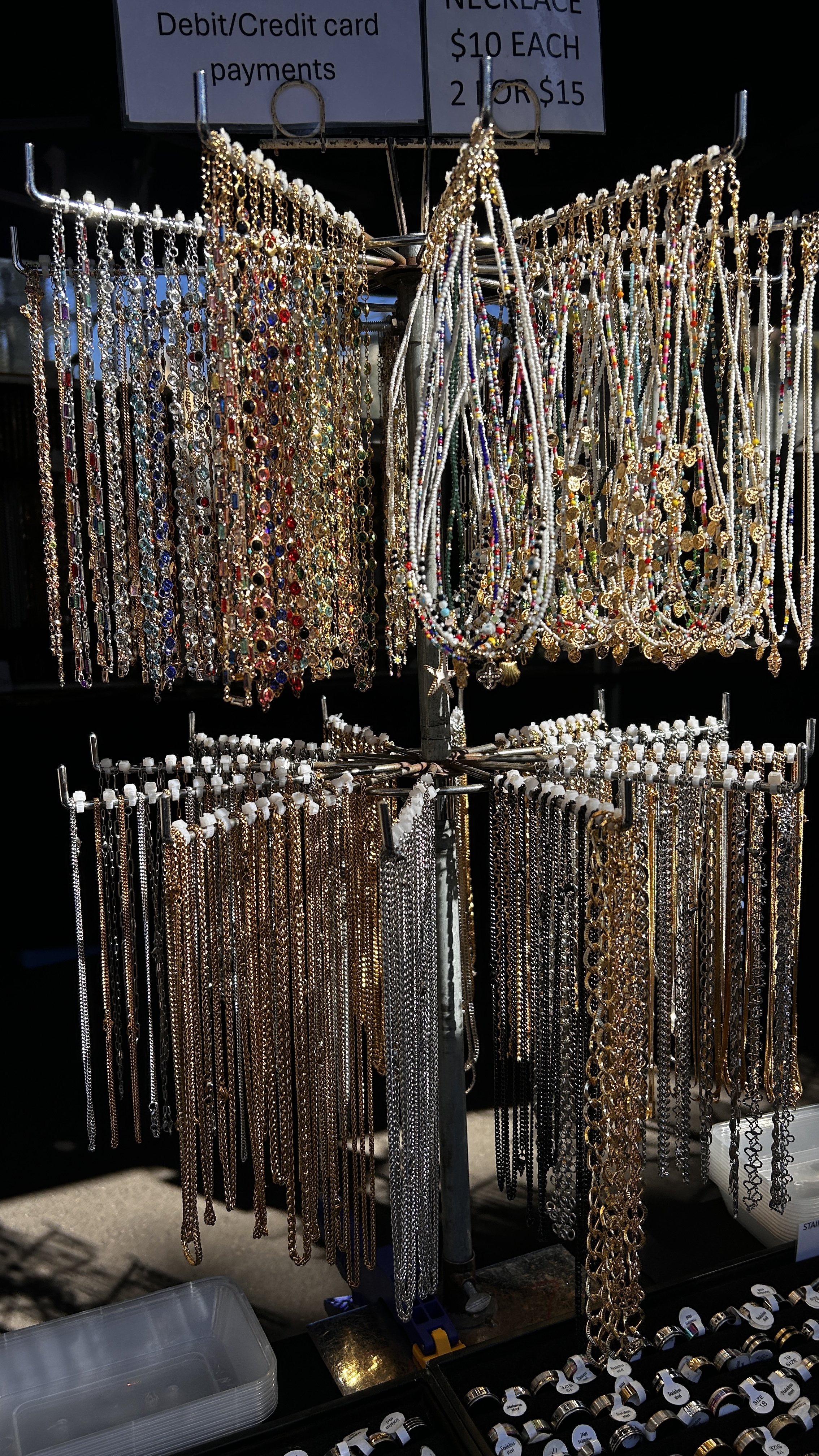 Gold, silver and beaded necklaces hanging at Fatma’s market stall.
