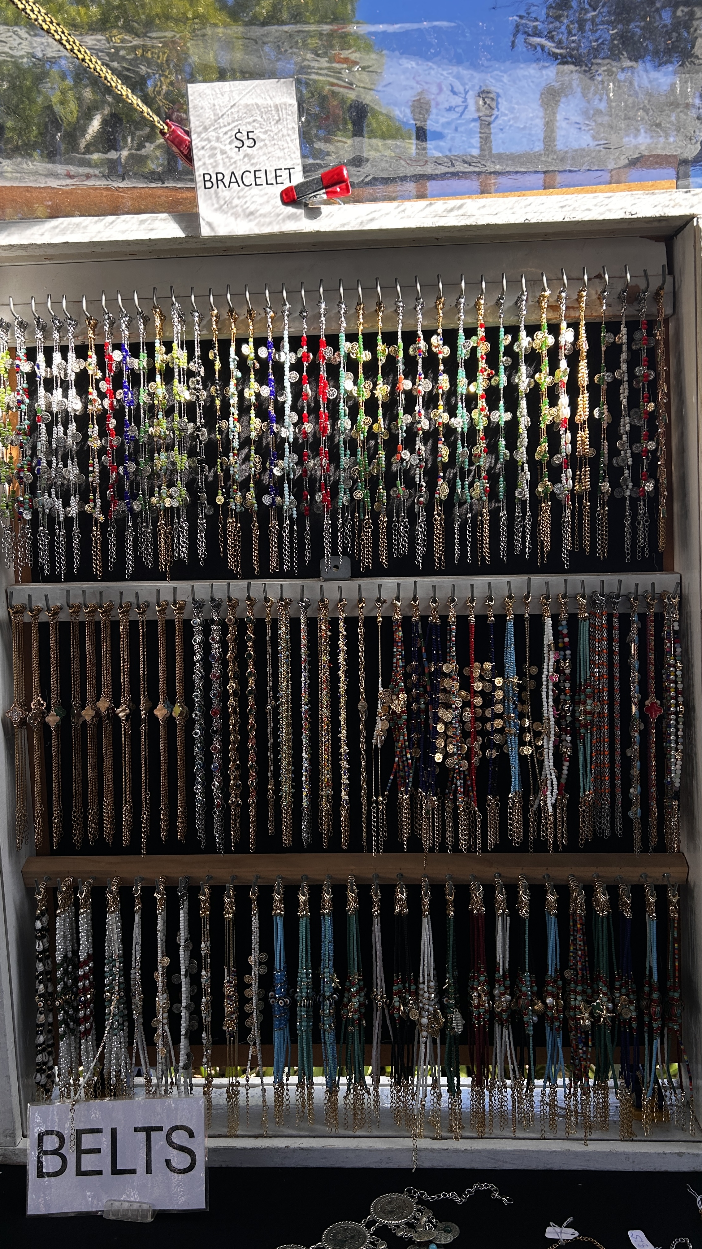 Rows of colourful beaded charm bracelets at the market stall.