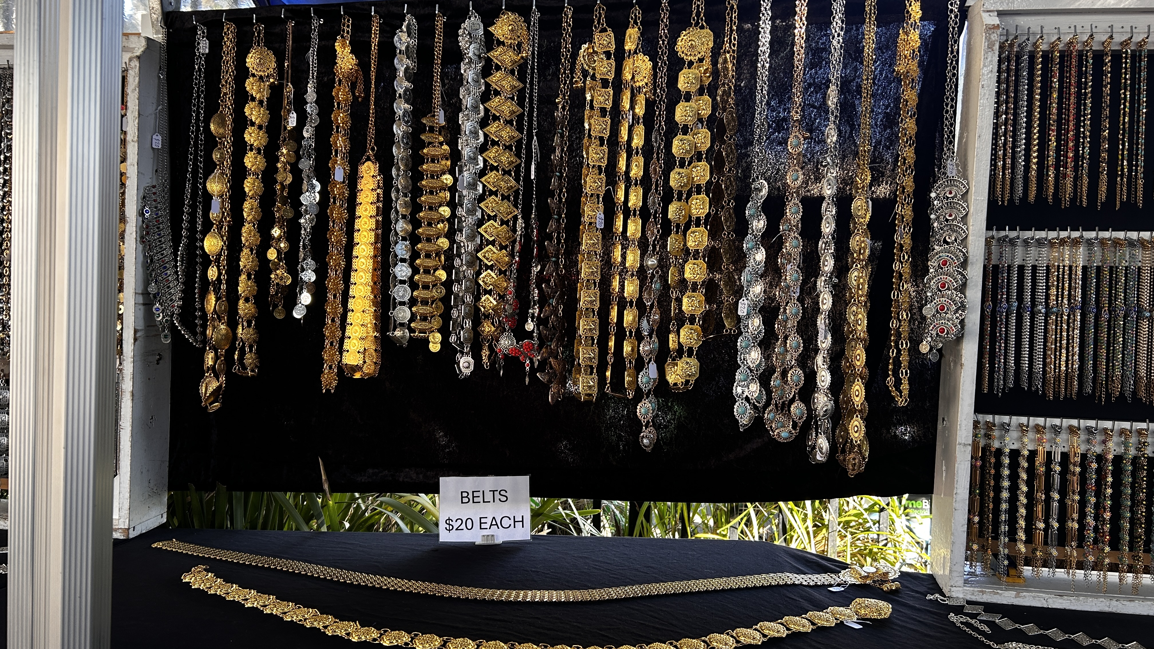 Gold and silver-tone statement belts displayed at the jewellery stall.
