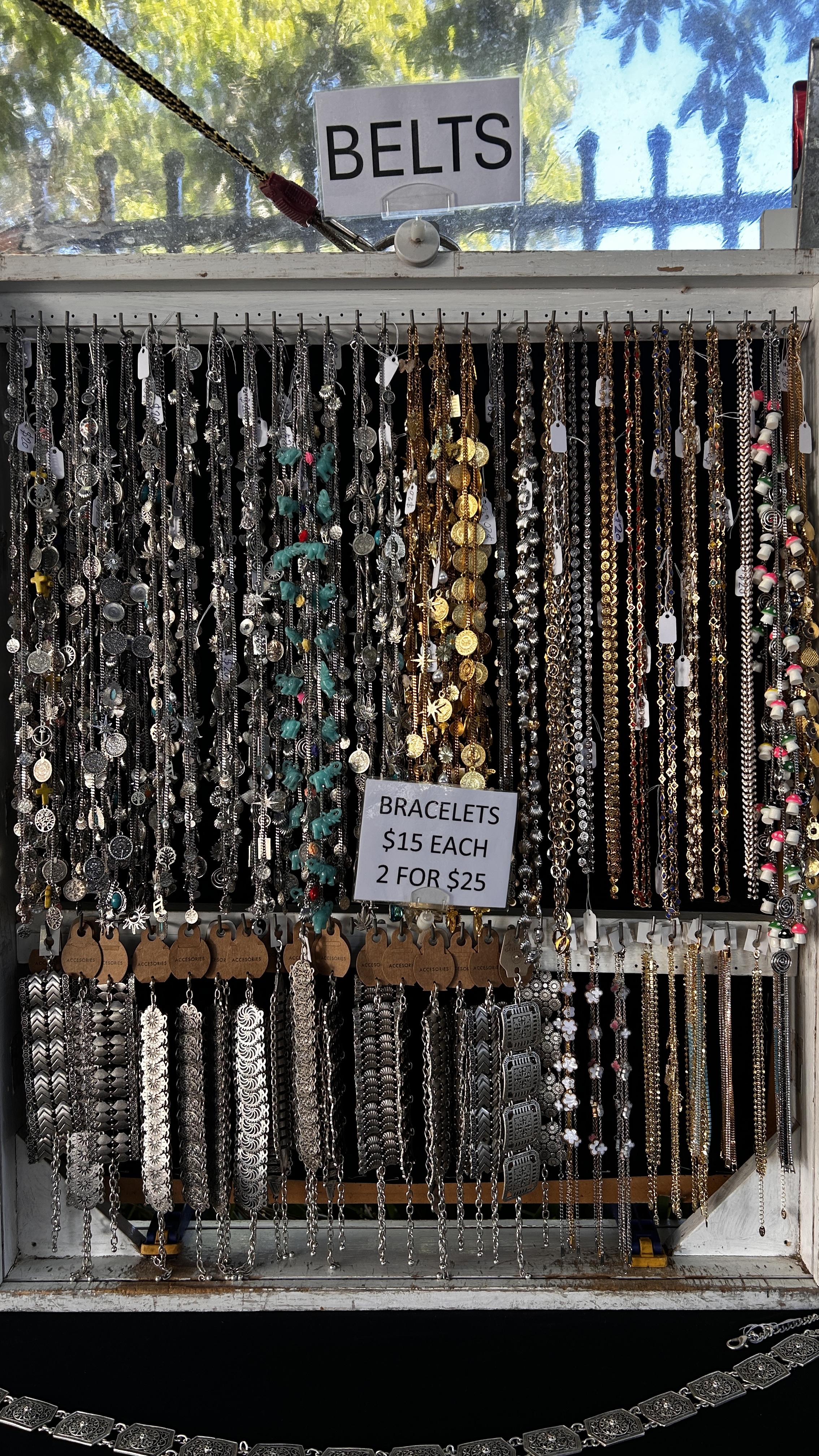 A market display with charm bracelets, chains and earrings.